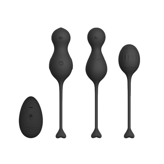 Set of black silicone kegels or massage tools with a black remote control on a transparent background